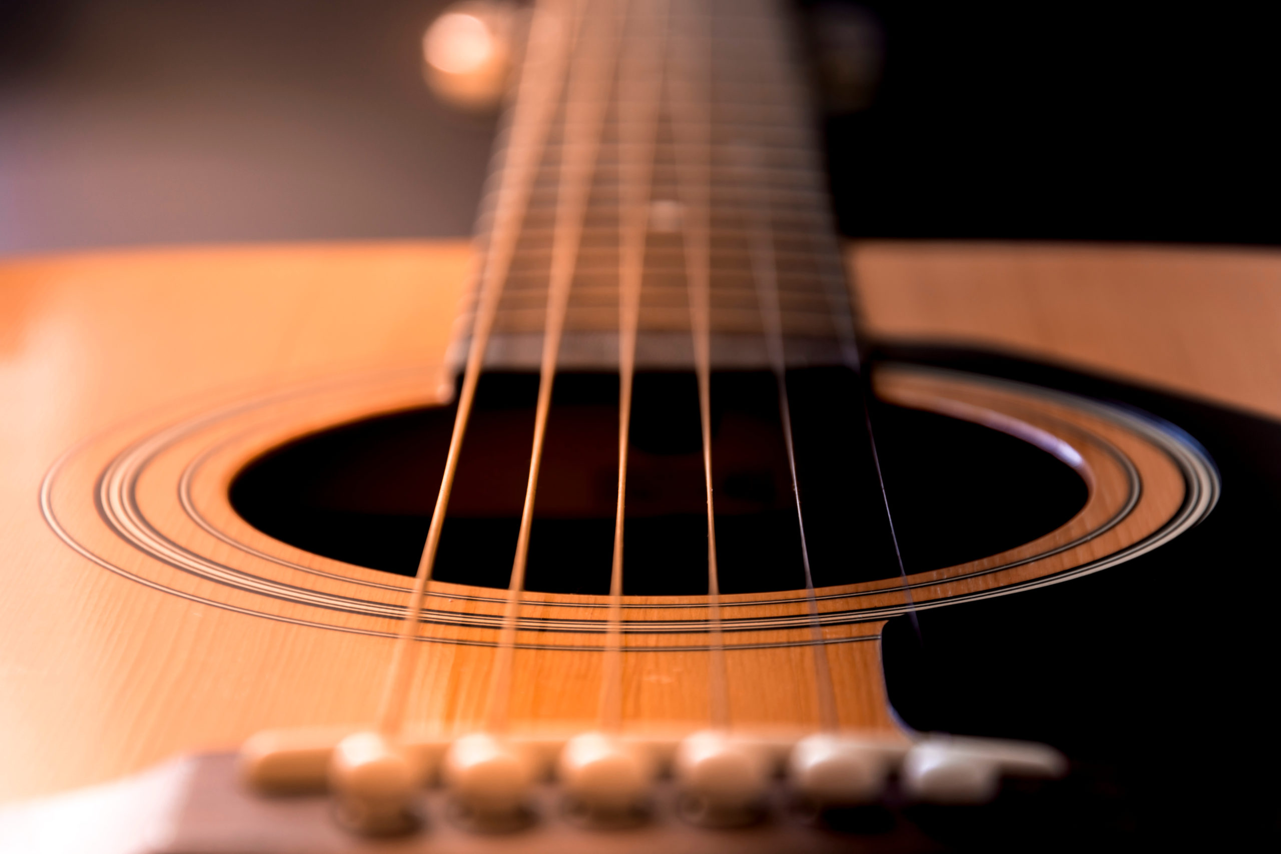 close up of acoustic guitar strings right before a recital
